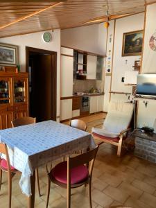 a kitchen and living room with a table and chairs at Appartamento Edolo in Edolo