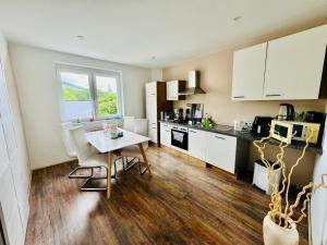 a kitchen with a table and chairs and a dining room at Sollstedt Ferienwohnung in Sollstedt