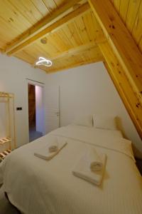 a bedroom with a large white bed with wooden ceilings at Ala World Resort in Kartepe +35 photos