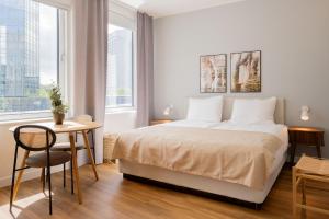 a bedroom with a bed and a table and a window at Limehome Amsterdam Westerpark in Amsterdam