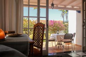 a dining room with a table and a glass door at Villa Finca El Drago in La Orotava