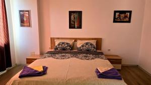 a bedroom with a bed with two pillows on it at Grand Apartment Pomorie in Pomorie