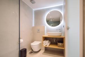 Un baño con lavabo, inodoro y espejo. en ARCH HOME, luxury property with private parking, en La Canea 27 fotos más