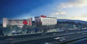 a large building with a sbs sign in front of a highway at The Rose Gaming Resort in Dumfries