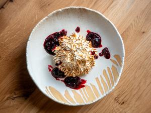 a white bowl filled with pasta and berries on a table at The Nici in Bournemouth