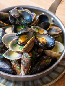 a bowl filled with mussels on top of a table at The Nici in Bournemouth