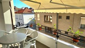 a balcony with a table and chairs on a balcony at Grand Apartment Pomorie in Pomorie