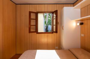 a bedroom with a bed and a window at Camping Europa in Marina di Massa