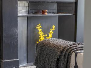 a fireplace with a blanket on top of it at Pass the Keys West End Cosy Pop of Colour in Glasgow