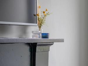 a table with a vase of flowers on it at Pass the Keys West End Cosy Pop of Colour in Glasgow