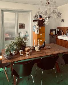 a kitchen with a large wooden table and chairs at St'ngt in Borrby