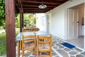 a table and chairs on the patio of a house at Melissa Gold Coast in Psakoudia
