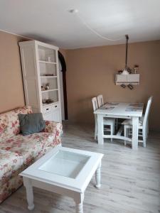 a living room with a couch and a table at Fewo Froschkönig in Schieder-Schwalenberg