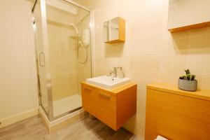a bathroom with a sink and a shower at Henrys Apartment, DO NOT BOOK UNLESS YOU LIKE CLUB NOISE in Dundee