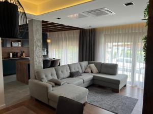 a living room with a couch and a kitchen at Residence 4U in Malinska