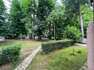 a path in a park with trees and bushes at Villa by Expert Aleja in Sarajevo