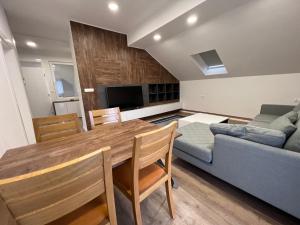 a kitchen and living room with a table and a couch at Villa by Expert Aleja in Sarajevo