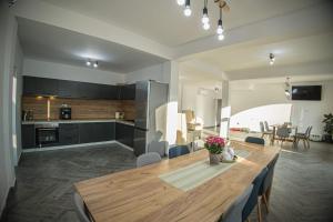 a kitchen and dining room with a large wooden table at Mala House in Orşova