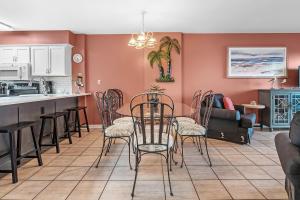 a kitchen and living room with a table and chairs at 6512 Gulf Shores Plantation-Palms in Gulf Shores