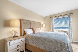 a bedroom with a bed with a dresser and a window at 6512 Gulf Shores Plantation-Palms in Gulf Shores +40 photos