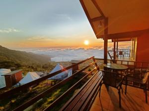 a view from the balcony of a house with the sunset at Nuea Tawan at Phu Thap Buek in Ban Tha Kok Hai