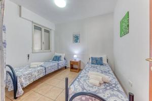 En eller flere senge i et værelse på Rosso Tramonto By Vivimy