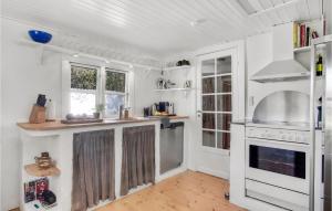a kitchen with white walls and white appliances at 3 Bedroom Lovely Home In Nykøbing Sj in Nykøbing Sjælland