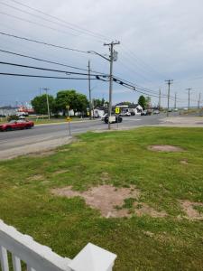 a field of grass on the side of a street at Appartement de la rive in Shippagan +4 photos