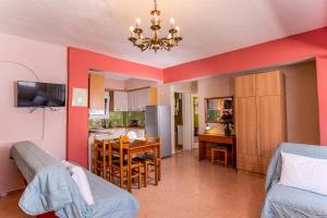 a living room with a kitchen and a dining room at Melissa Gold Coast in Psakoudia