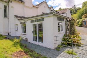 a white house with glass doors on a street at Grasmere View, stunning views over Grasmere Lake, ideal romantic break in Grasmere +19 photos