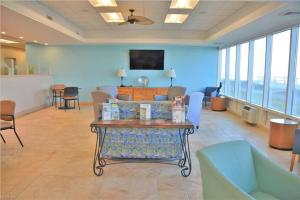 a living room with a couch and chairs and a table at Oceanfront condo, ocean view and indoor pool in Virginia Beach