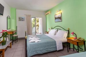 a bedroom with a bed and a table and a desk at Melissa Gold Coast in Psakoudia +118 photos