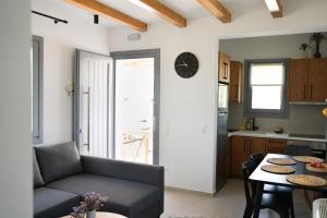 a living room with a couch and a table at Pyrra apartments in Skiros