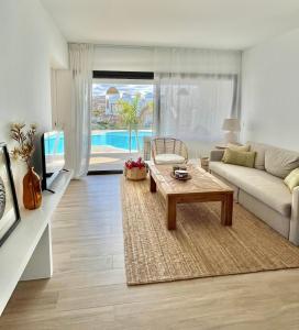 a living room with a couch and a coffee table at Casita Oliva - Piso de diseño en Fuerteventura in La Oliva +22 photos