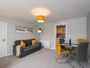 a living room with a couch and a table at Hamilton House Holiday Apartment in Killyleagh