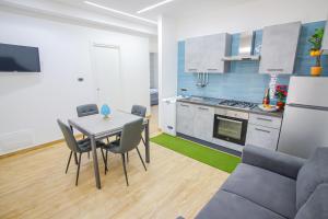 a kitchen and living room with a table and a couch at Villa Teresa Relax in Corbara +24 photos