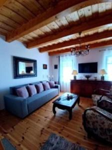 a living room with a couch and a coffee table at Panorámaház Lovason in Lovas