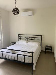 a bedroom with a bed with a black metal frame at GreenHouse del lago in Viverone