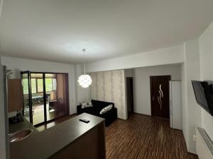 a living room with a couch and a table at Rim1 in Piteşti