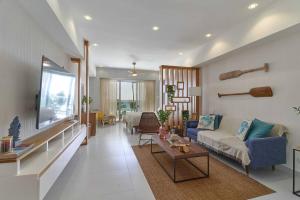 a living room with a couch and a table at Aquarella Sunset Caribbean Beachfront Gataway in La Puntica de Juan Dolio