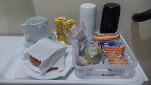 a refrigerator with a sandwich and other food on it at Deslize Motel 4 in Porto Alegre