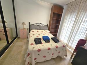 a bedroom with a bed with two pillows on it at ALMERIA CENTRO y CONFORT in Almería