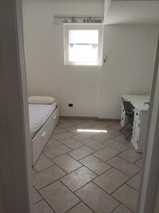 a room with a bed and a desk and a window at La Casetta Bianca in Follonica