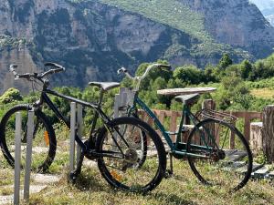 a bike is parked next to a fence at Camping Lekdushi - Shehu in Tepelenë