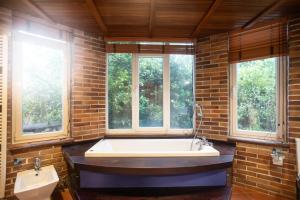 a large bathroom with a large tub and windows at Casa Armonía Natura, Villa, Loft & Casa estudio in Camargo +61 photos