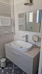 a bathroom with a white sink and a mirror at B&B Villa Gaia in Pizzo
