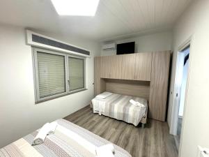 Voodi või voodid majutusasutuse Siclari B&B-Rooms&Suite toas