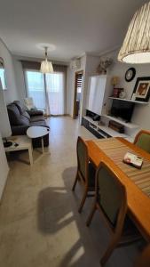 a living room with a table and a couch at Apartamento Torre la Sal in Cabanes