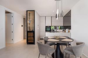 a kitchen with a dining room table and chairs at Dream by the sea in Opatija