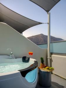 a bath tub sitting on top of a balcony at Smaragdi in Perivolos